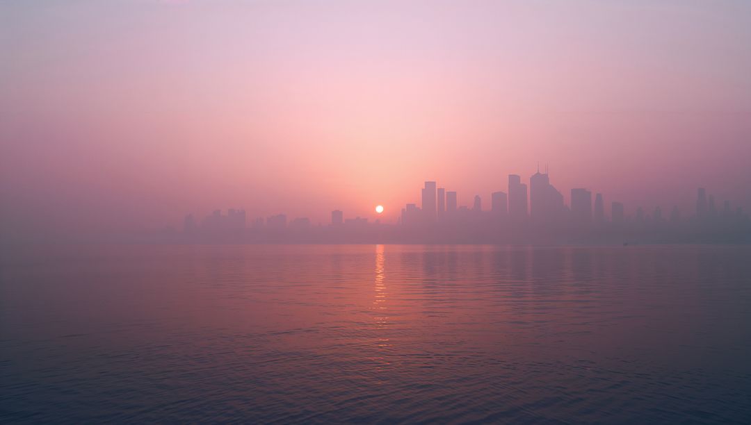 Tranquil skyline at sunrise reflecting over serene waterfront