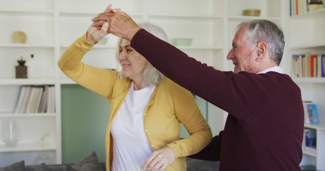 Senior Couple Dancing Happily Together in Living Room - Free Images, Stock Photos and Pictures on Pikwizard.com