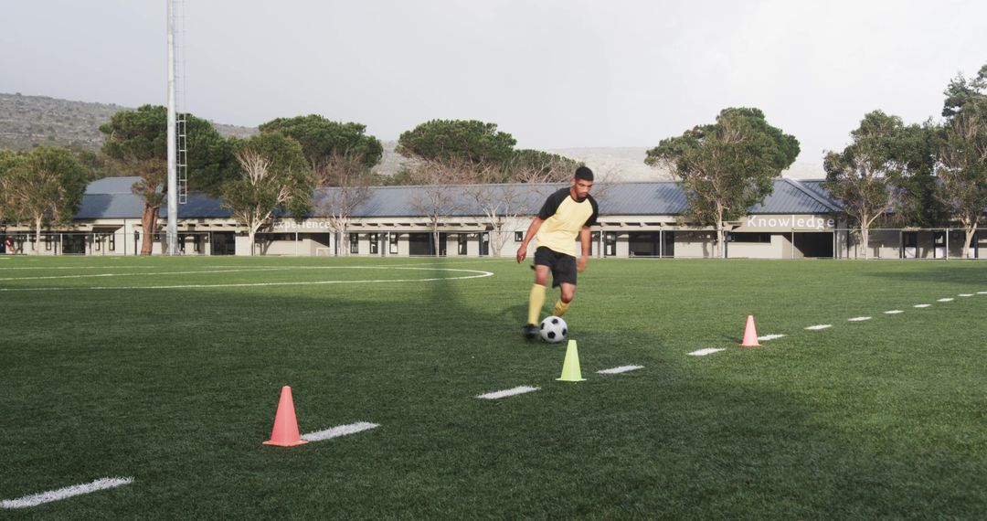 Youth Soccer Player Practicing Dribbling Skills on Field