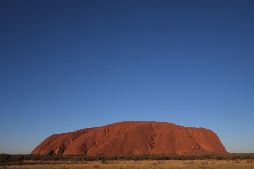 Majestic Uluru Rock Under Clear Blue Sky - Free Images, Stock Photos and Pictures on Pikwizard.com