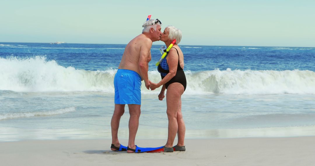 Senior Couple Kissing on Beach with Snorkeling Gear - Free Images, Stock Photos and Pictures on Pikwizard.com