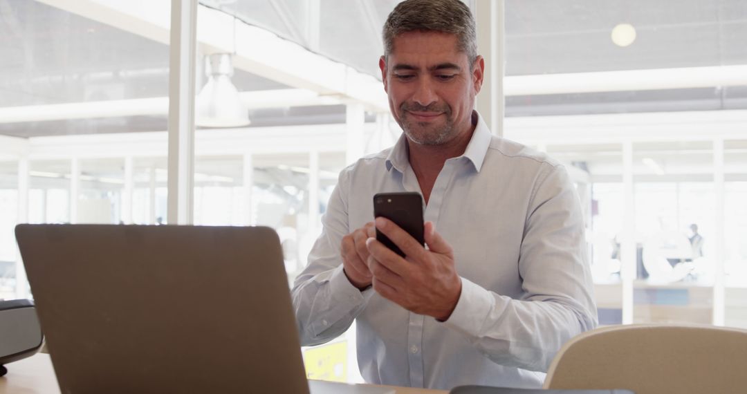 Businessman Using Smartphone During Office Work - Free Images, Stock Photos and Pictures on Pikwizard.com