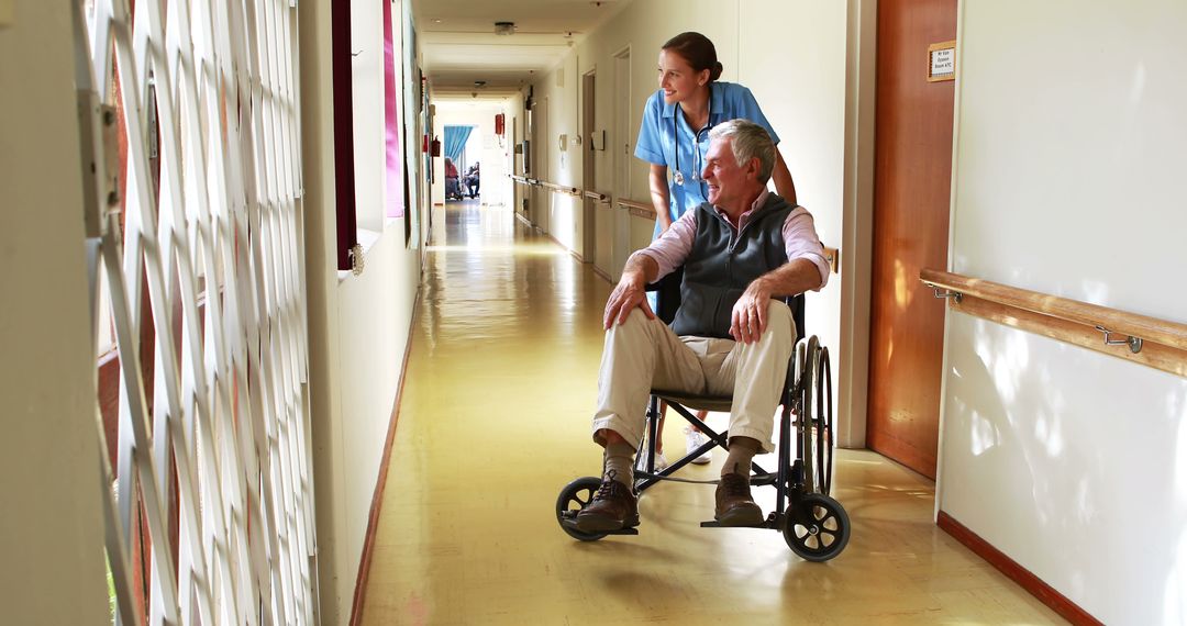 Nurse Assisting Senior Man in Wheelchair Down Hospital Corridor - Free Images, Stock Photos and Pictures on Pikwizard.com