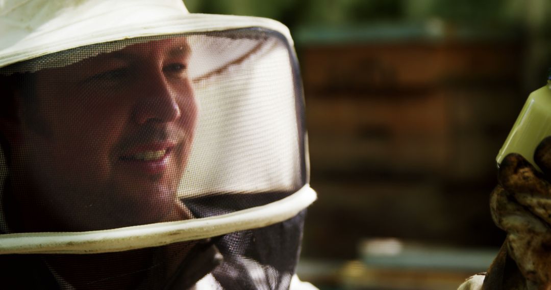 Beekeeper Smiling in Protective Gear at Apiary - Free Images, Stock Photos and Pictures on Pikwizard.com