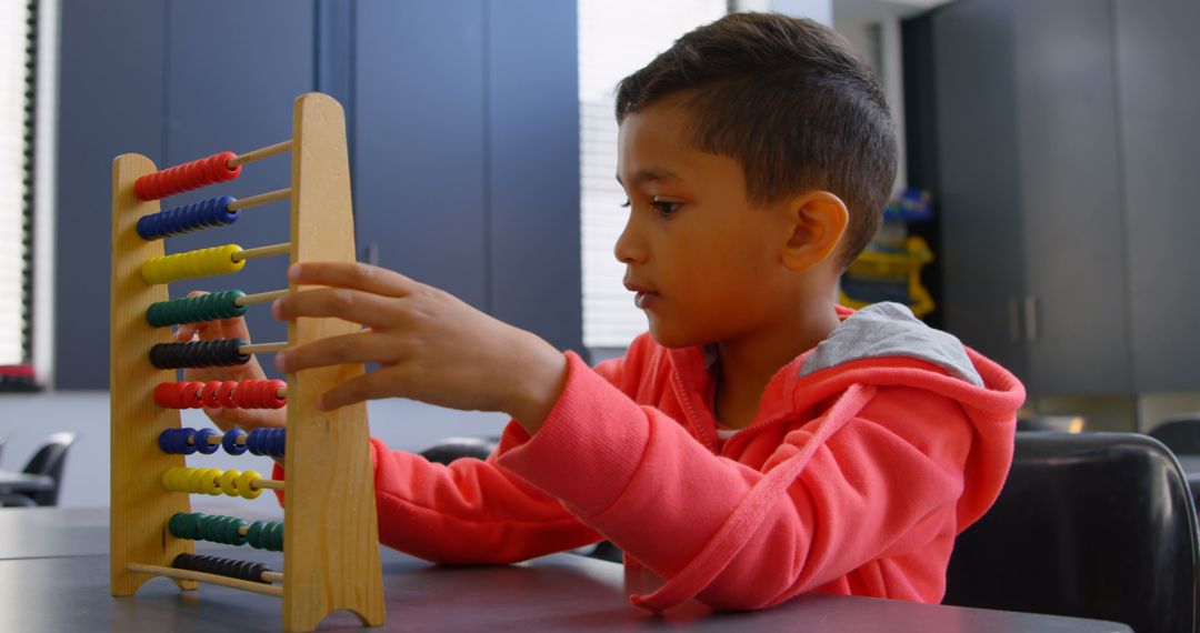 Schoolboy Using Abacus for Math Problem in Classroom