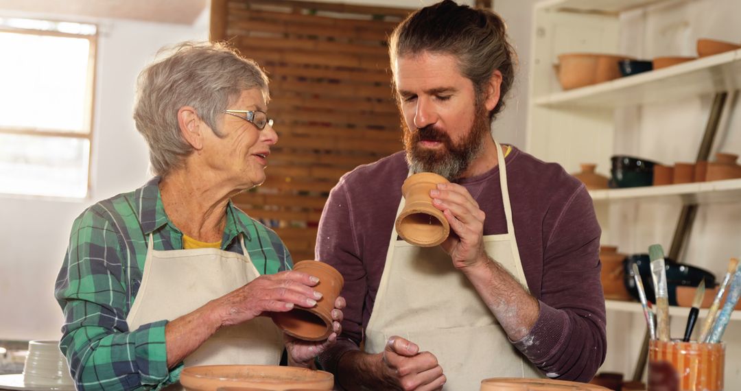 Elderly Woman and Young Man Enjoying Pottery Making Together - Free Images, Stock Photos and Pictures on Pikwizard.com