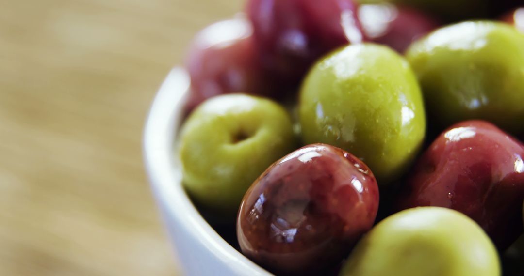 Close-Up of Green and Red Olives in White Bowl - Free Images, Stock Photos and Pictures on Pikwizard.com