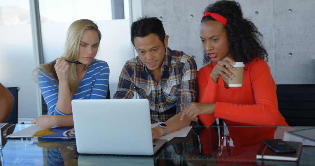 Diverse Team of Professionals Collaborating with Laptop