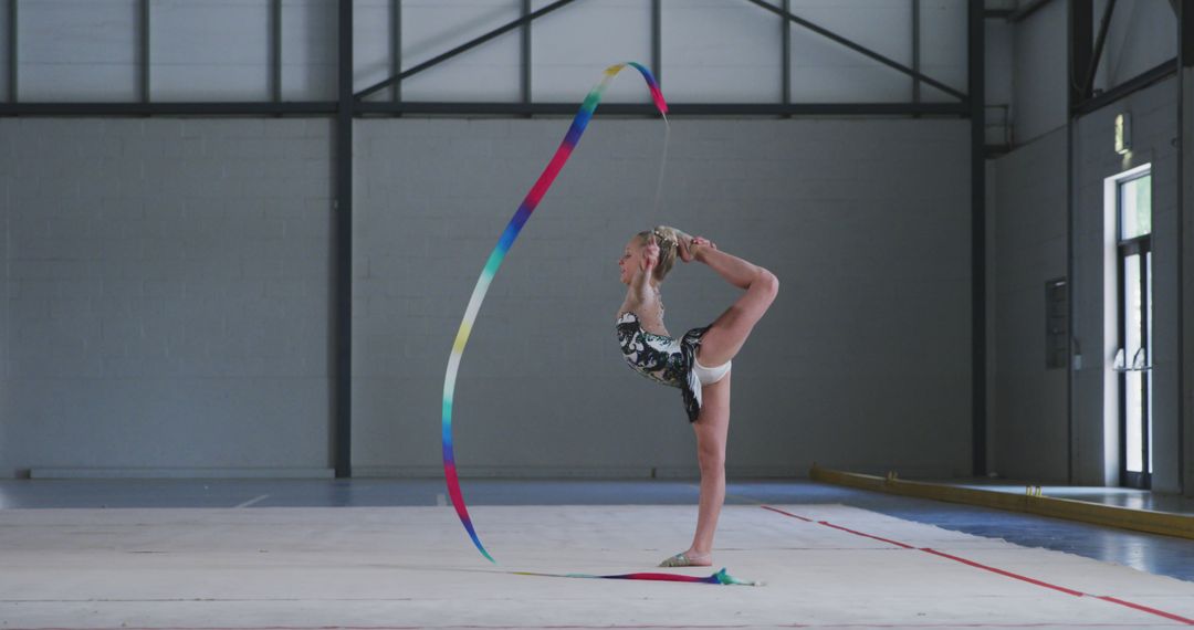 Young Gymnast Practicing Rhythmic Gymnastics with Ribbon in Gymnasium - Free Images, Stock Photos and Pictures on Pikwizard.com