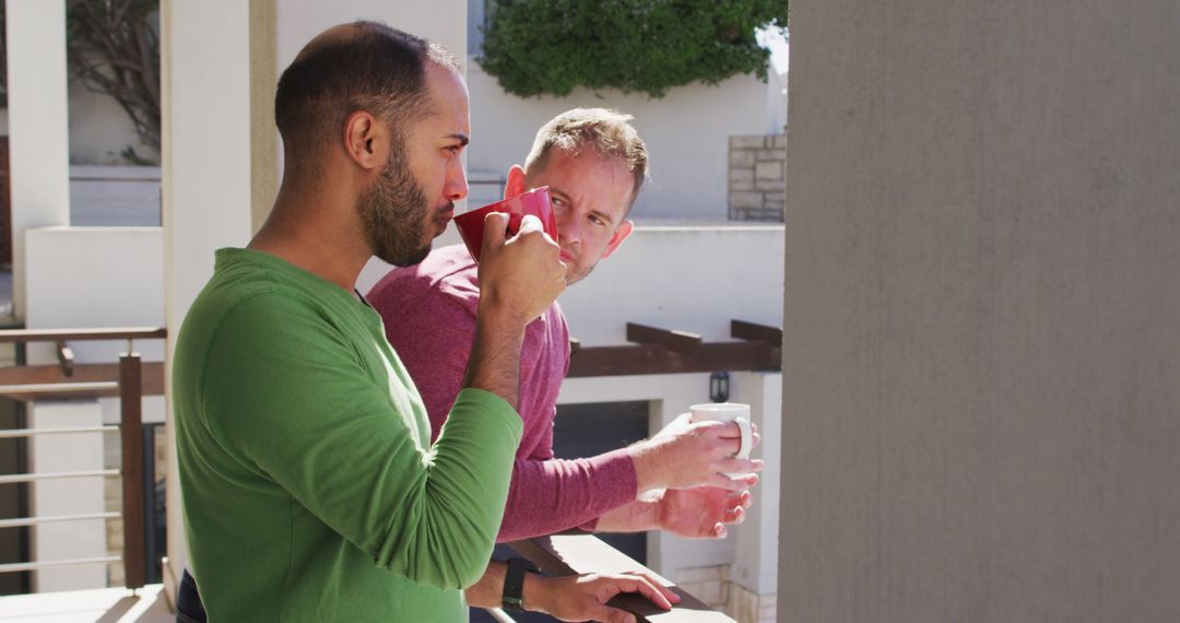 Two Friends Enjoying Coffee on Balcony During Daytime - Free Images, Stock Photos and Pictures on Pikwizard.com