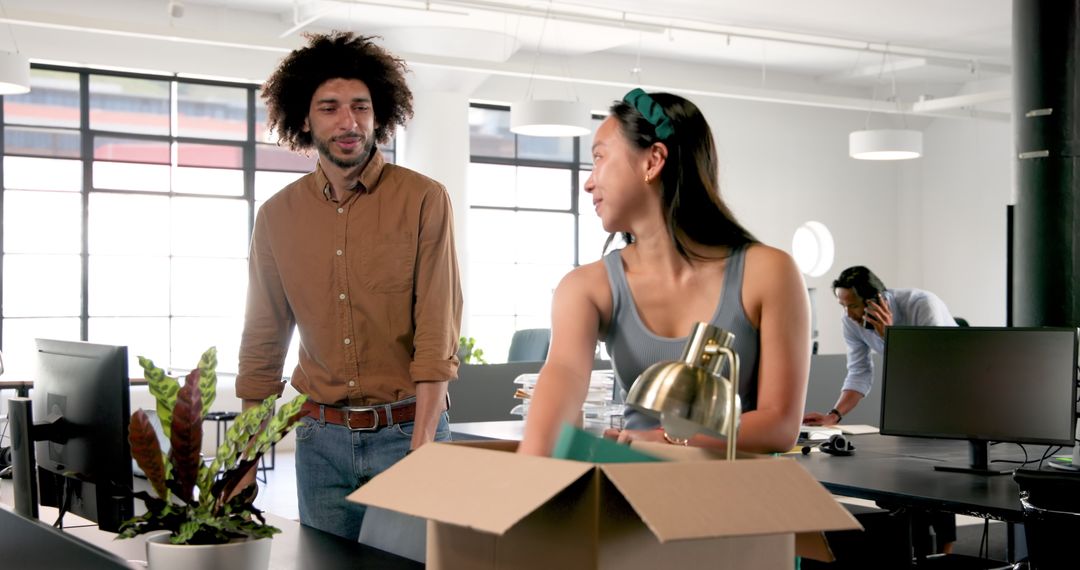Colleagues Unpacking Box in Modern Office, Teamwork and Communication