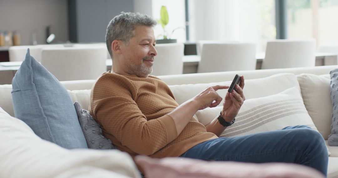 Senior Man Relaxing on Couch Using Smartphone - Free Images, Stock Photos and Pictures on Pikwizard.com