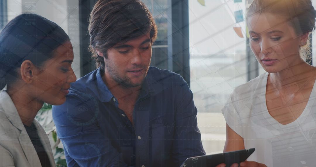 Diverse Colleagues Collaborating Over Digital Tablet with Data Overlay