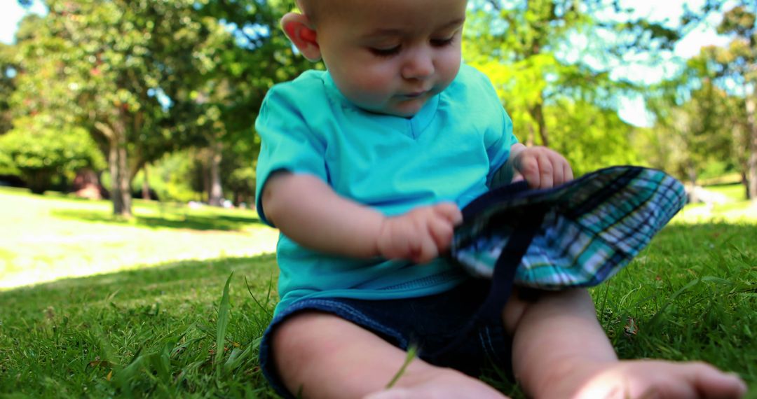 Cute Baby Playing on Grass in Sunny Park - Free Images, Stock Photos and Pictures on Pikwizard.com