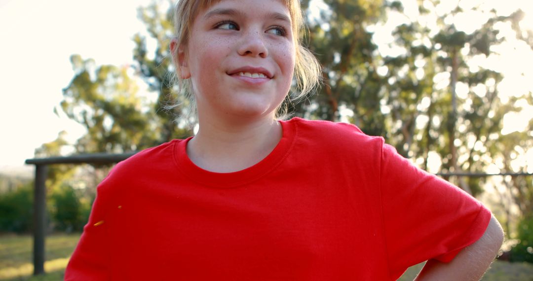 Content girl in red shirt smiles during outdoor playtime - Free Images, Stock Photos and Pictures on Pikwizard.com