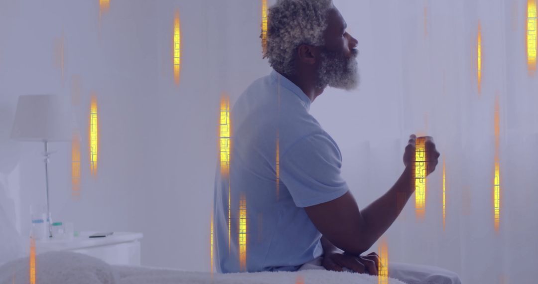 Conceptual technology theme overlaid on pensive biracial man on bed