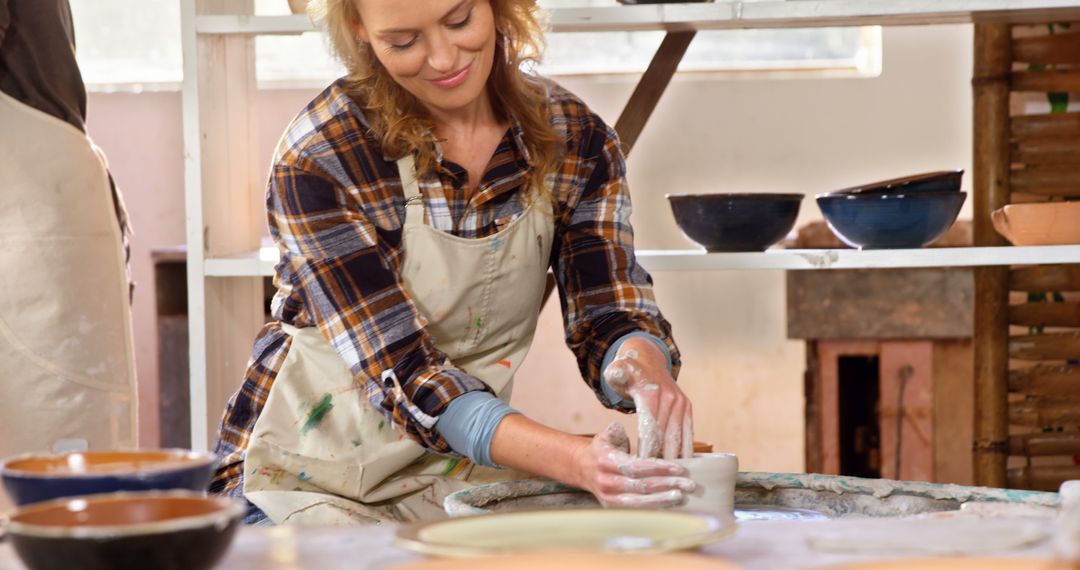 Woman Creating Pottery on Wheel in Artisan Studio - Free Images, Stock Photos and Pictures on Pikwizard.com