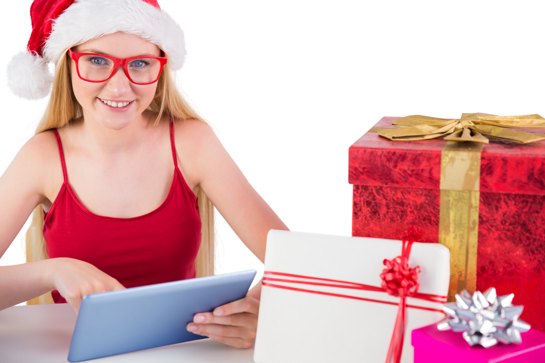 Festive Blonde Wearing Santa Hat Shopping Online with Tablet and Christmas Gifts - Download Free Stock Images Pikwizard.com