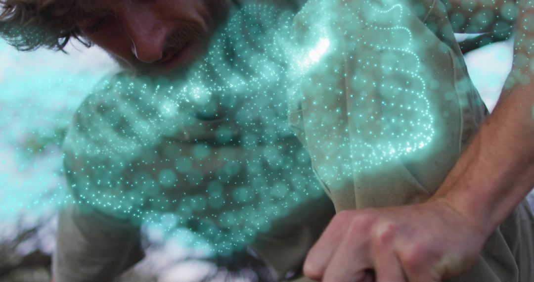 Man Interacting with Holographic Turquoise Mesh in Outdoor Setting