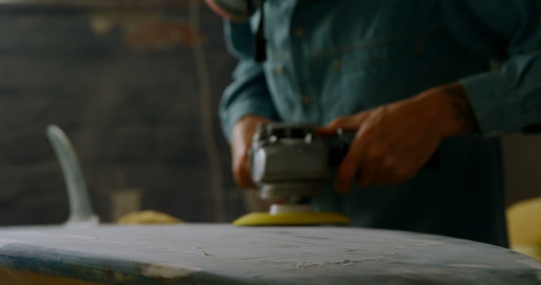 Craftsman Buffing Surfboard with Power Tool in Workshop - Free Images, Stock Photos and Pictures on Pikwizard.com