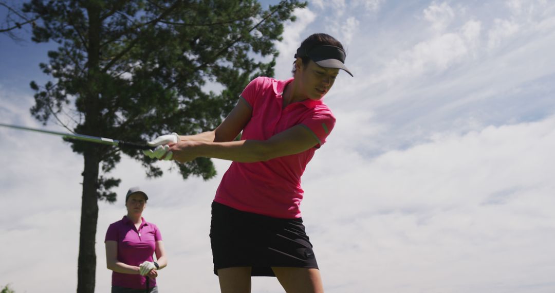 Women Golfers Practicing Swing on Sunny Day Outdoors - Free Images, Stock Photos and Pictures on Pikwizard.com