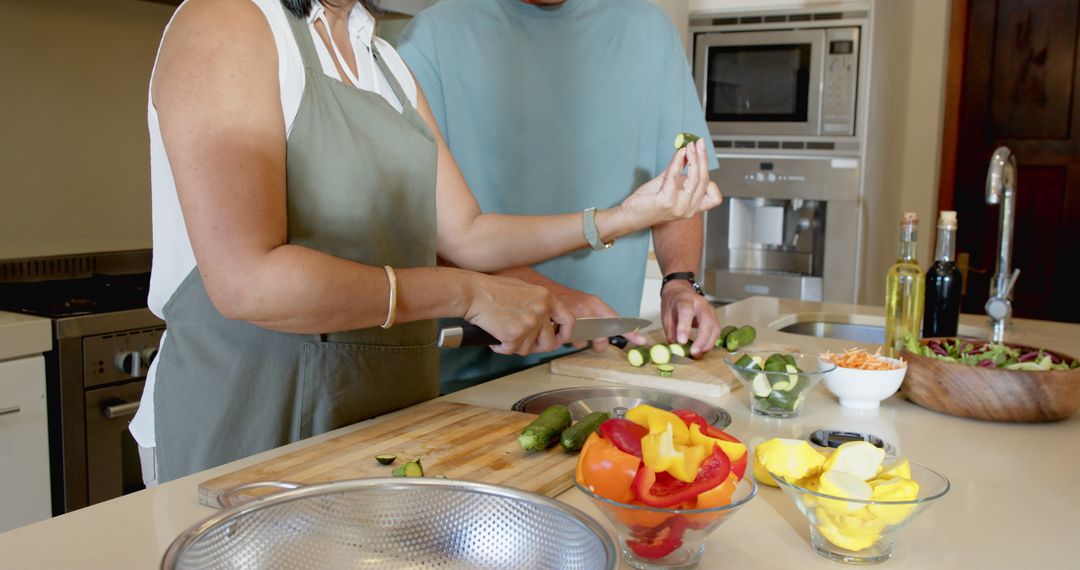 Diverse Couple Preparing Fresh Salad in Modern Kitchen