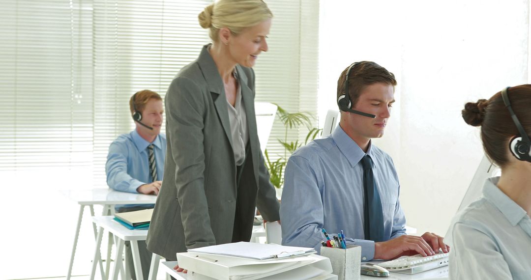 Customer Service Team Using Headsets in Modern Office, Professional Support - Free Images, Stock Photos and Pictures on Pikwizard.com