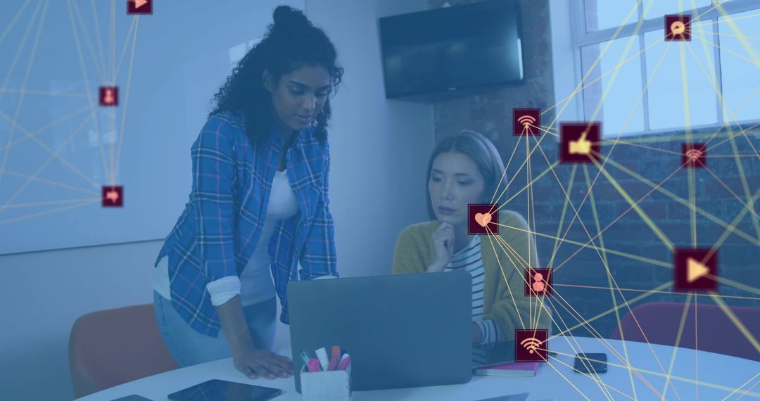 Two Women Collaborating on Laptop with Digital Network Overlay for Tech Teamwork