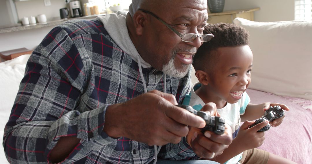 Grandfather and Grandson Playing Video Games Together at Home - Free Images, Stock Photos and Pictures on Pikwizard.com