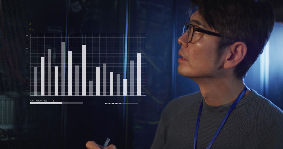 Asian IT Professional Analyzing Graphical Data in Server Room