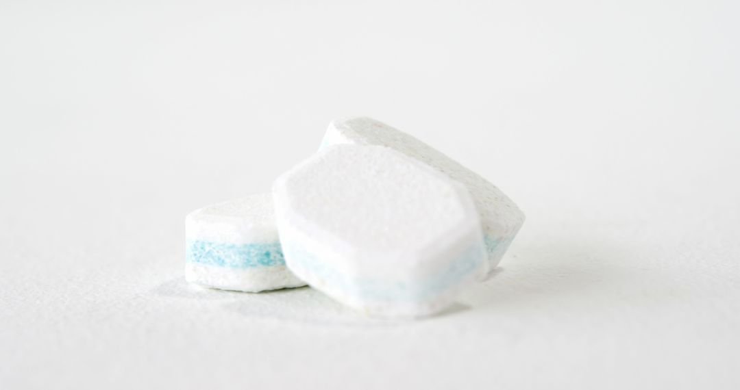 Dishwasher tablets are displayed against a clean white background, with copy space - Free Images, Stock Photos and Pictures on Pikwizard.com