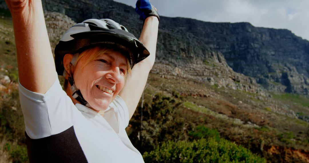 Happy Senior Woman Celebrating Mountain Bike Ride in Nature - Free Images, Stock Photos and Pictures on Pikwizard.com