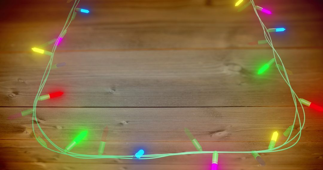 Colorful Fairy Lights on Wooden Background Celebration Concept - Free Images, Stock Photos and Pictures on Pikwizard.com