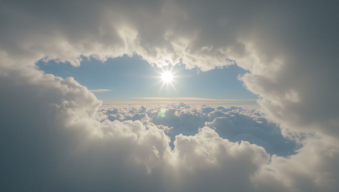 Sunburst through circular cloud opening over endless high-altitude cloudscape