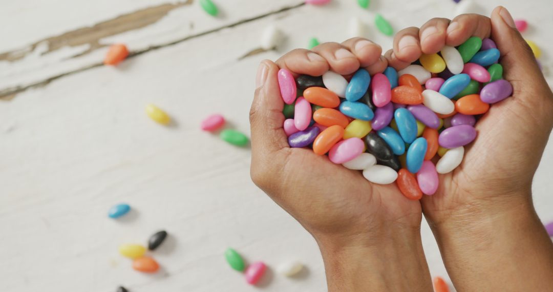 Colorful Jelly Beans in Heart Shape in Hands - Free Images, Stock Photos and Pictures on Pikwizard.com