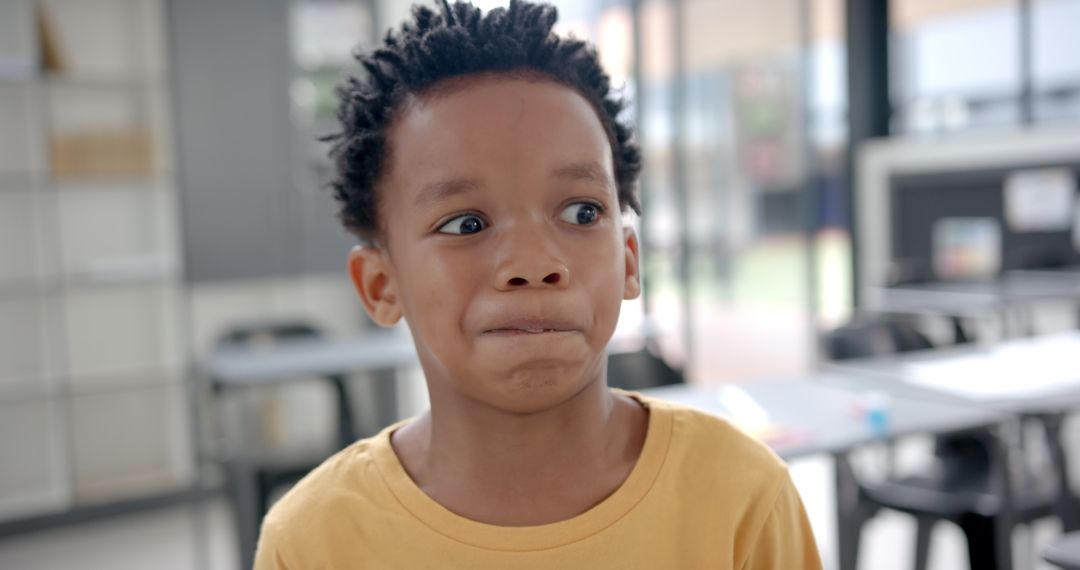 Young Boy Expressing Uncertainty in Classroom Setting