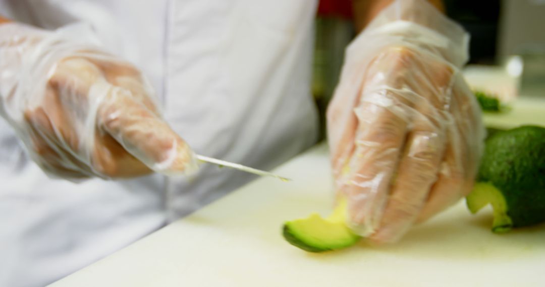 Close Up of Hands Cutting Avocado with Knife in Kitchen - Free Images, Stock Photos and Pictures on Pikwizard.com