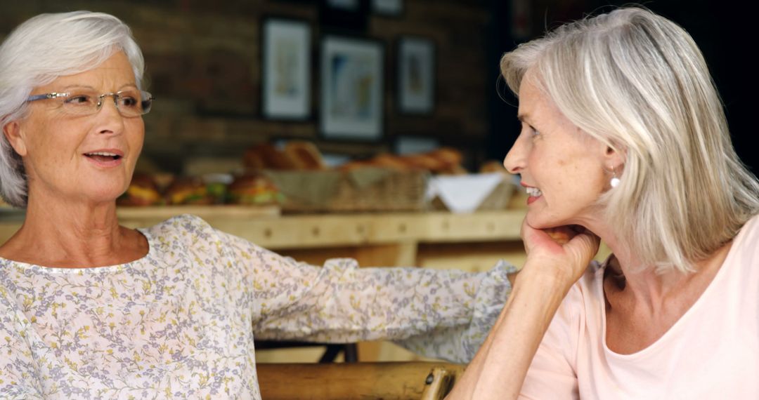 Senior Women Engaging in Conversation at Cozy Cafe - Free Images, Stock Photos and Pictures on Pikwizard.com