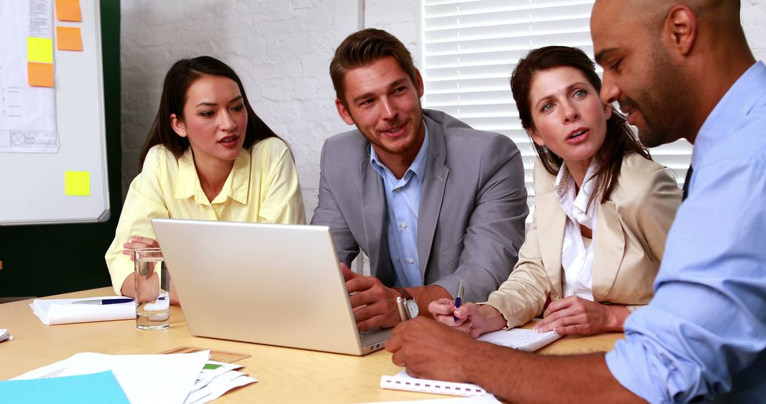 Casual Business Meeting with Diverse Team Using Laptop
