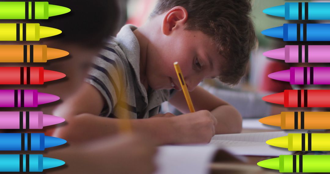 Focused Schoolboy Writing Surrounded by Colorful Crayons