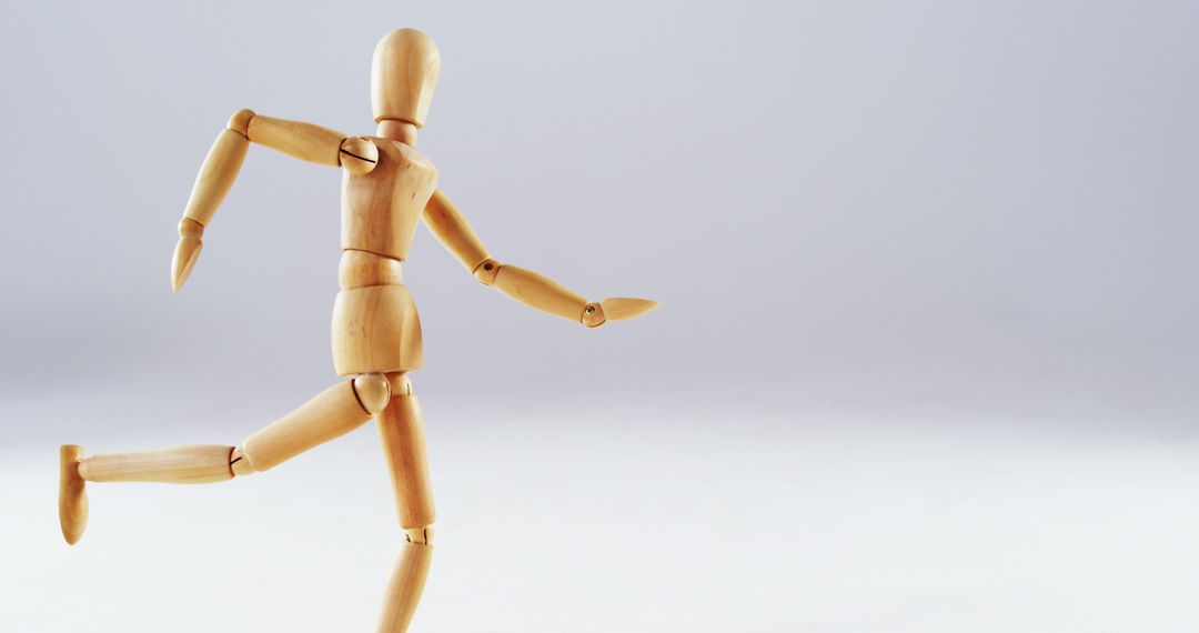 Wooden Art Mannequin Running on White Background - Free Images, Stock Photos and Pictures on Pikwizard.com