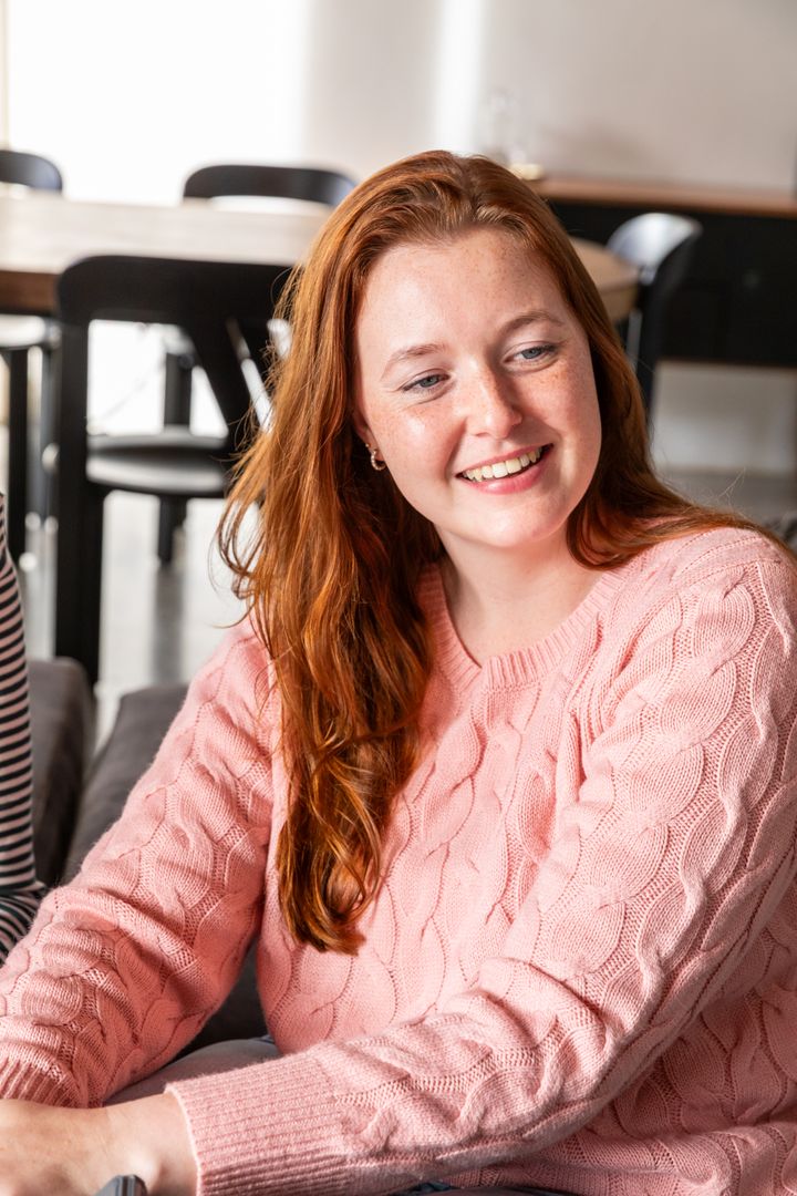 Smiling Woman Socializing in Modern Lounge Setting