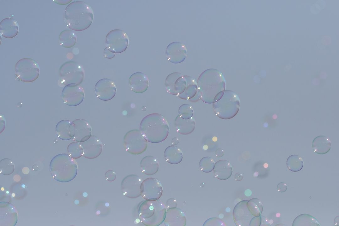 Floating Soap Bubbles Against Serene Sky