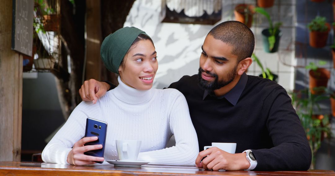 Couple in Cafe Enjoying Time Together with Smartphone