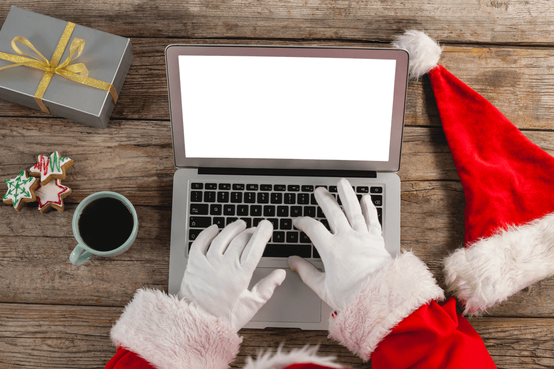 Santa Claus Typing on Laptop with Transparent Screen by Coffee and Cookies