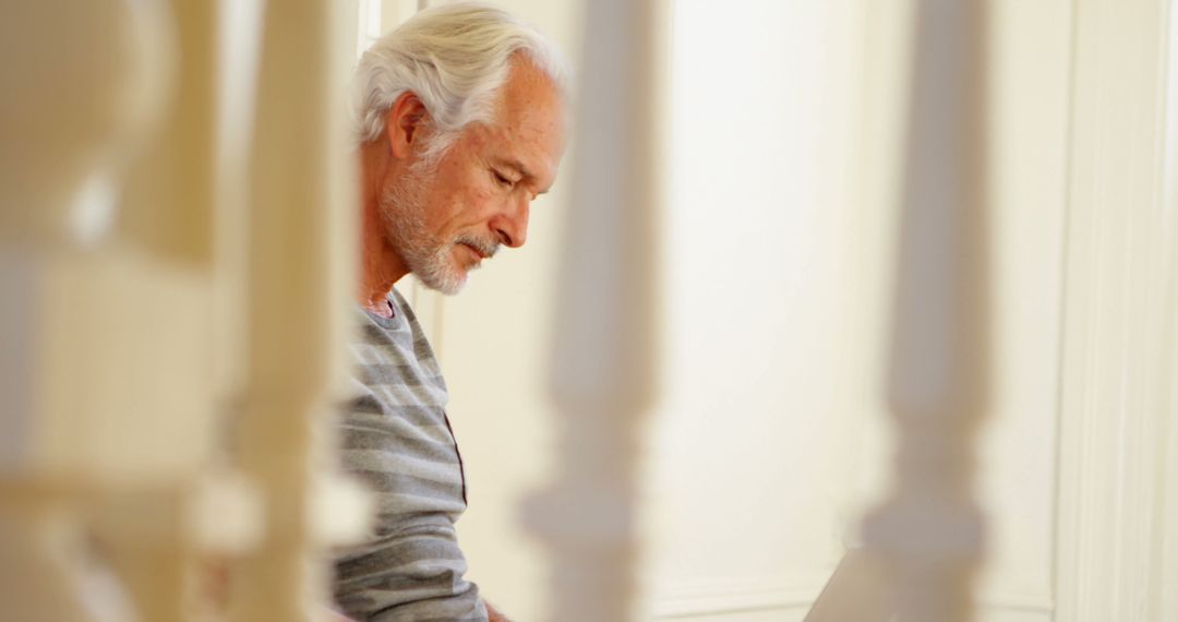 Senior Man with Laptop Sitting Indoors - Free Images, Stock Photos and Pictures on Pikwizard.com