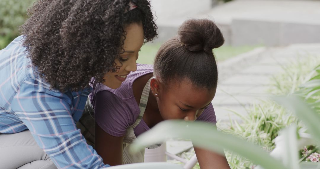 African American mother and daughter gardening together - Free Images, Stock Photos and Pictures on Pikwizard.com