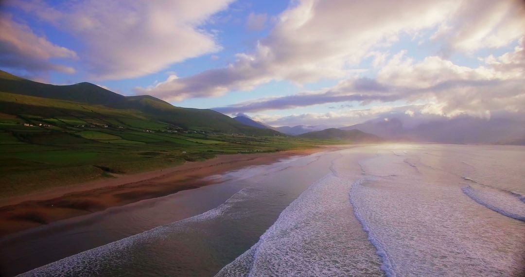 Drone View of Serene Coastal Beach with Waves and Rolling Hills - Free Images, Stock Photos and Pictures on Pikwizard.com
