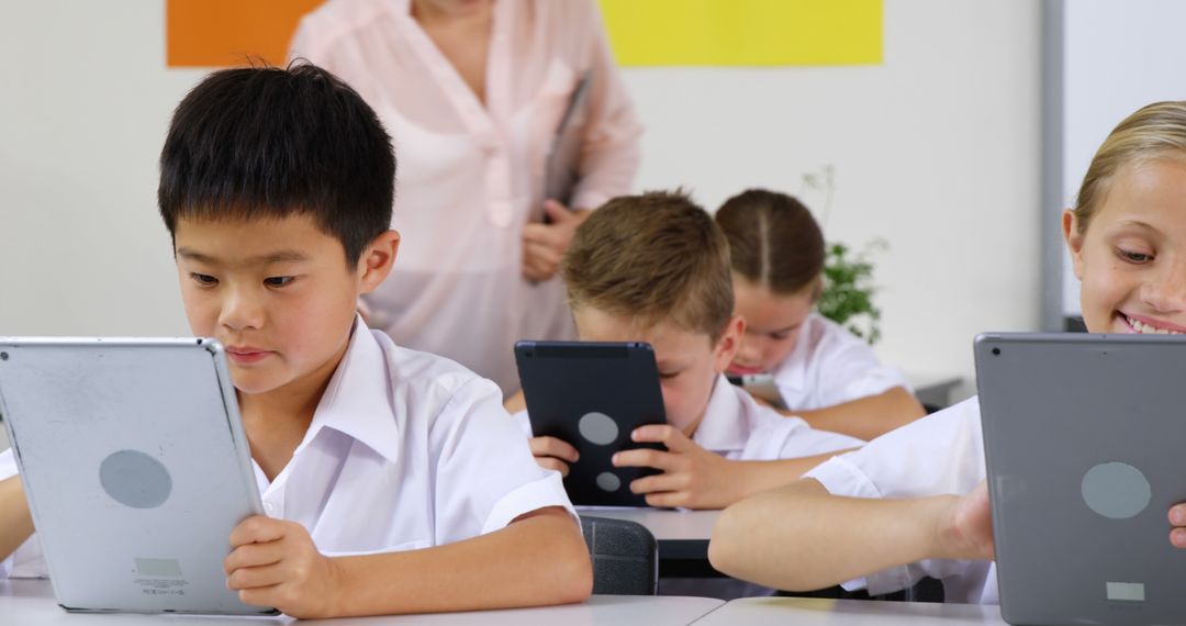 Schoolchildren Engaged with Tablets During Classroom Activity