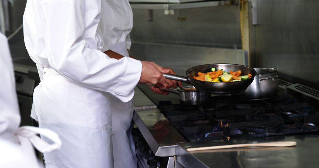 Professional Chef Cooking Vegetables in Restaurant Kitchen - Free Images, Stock Photos and Pictures on Pikwizard.com